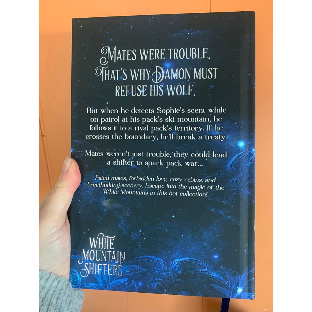 Book titled 'White Mountain Shifters' with a blue and black cover featuring text.