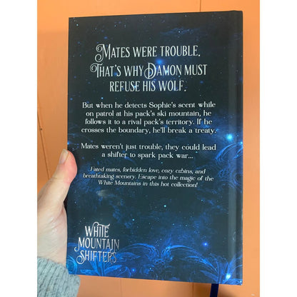 Book titled 'White Mountain Shifters' with a blue and black cover featuring text.