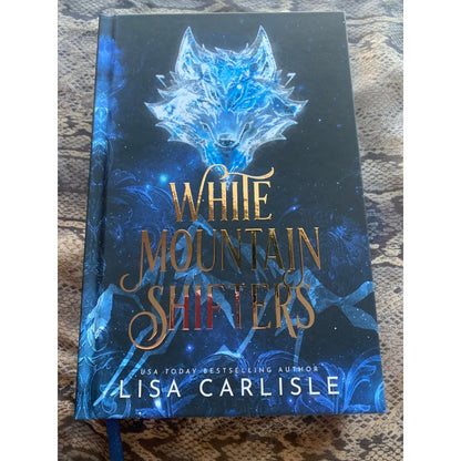 Book titled 'White Mountain Shifters' by Lisa Carlisle with a blue wolf design on the cover.